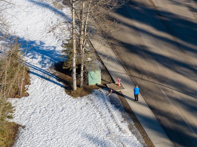 A person stands outside of Tumbler Ridge secondary school building where a shooting took place, leaving at least nine people dead in the small town of Tumbler Ridge, British Columbia, on February 11, 2026. Canada was in mourning Wednesday, Prime Minister Mark Carney said, after a lone shooter killed at least nine people, including seven at a school, and injured dozens more in a remote western town. (Photo by Eagle Vision Agency / AFP)