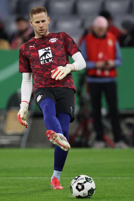 Leipzig's Hungarian goalkeeper #01 Peter Gulacsi warms up prior to the German Cup (DFB-Pokal) quarter-final football match between FC Bayern Munich and RB Leipzig in Munich, southern Germany on February 11, 2026. (Photo by Alexandra BEIER / AFP) / DFB REGULATIONS PROHIBIT ANY USE OF PHOTOGRAPHS AS IMAGE SEQUENCES AND QUASI-VIDEO.