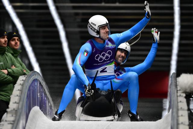 Italy's Ivan Nagler and Fabian Malleier react in the finish area of the luge men's doubles run 2 at Cortina Sliding Centre during the Milano Cortina 2026 Winter Olympic Games in Cortina d'Ampezzo on February 11, 2026. (Photo by Stefano RELLANDINI / AFP)