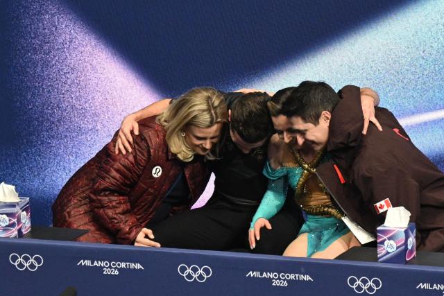 Canada's Marie-Jade Lauriault (2nd R) and Canada's Romain Le Gac (2nd L) react in the kiss and cry area after competing in the figure skating ice dance-free dance final during the Milano Cortina 2026 Winter Olympic Games at Milano Ice Skating Arena in Milan on February 11, 2026. (Photo by Antonin THUILLIER / AFP)