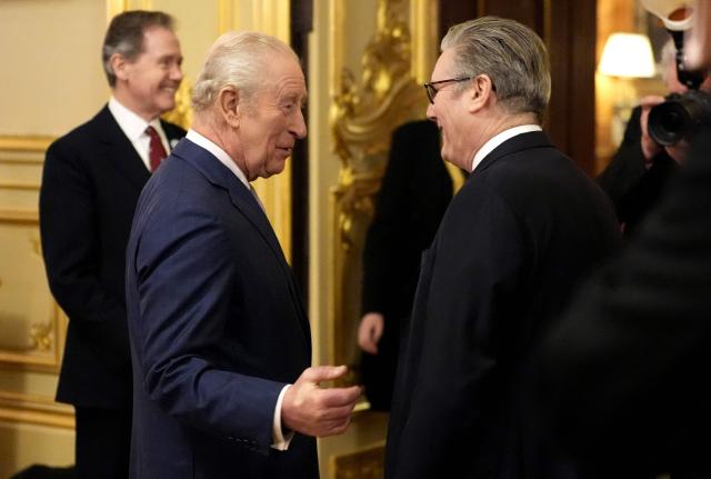 Britain's King Charles III talks to Britain's Prime Minister Keir Starmer during a reception to recognise the work of carers, at Windsor Castle in Windsor, west of London on February 11, 2026. (Photo by Andrew Matthews / POOL / AFP)