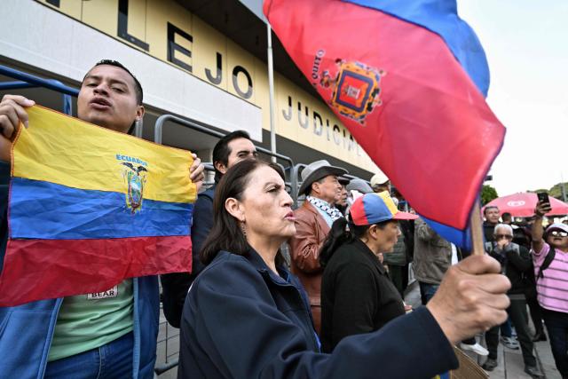 Supporters of Guayaquil mayor Aquiles Alvarez chant slogans calling for his release outside the North Judicial Complex in Quito on February 11, 2026. The mayor of Guayaquil, Aquiles Alvarez, and his brothers Xavier and Antonio, were detained on February 10, for alleged money laundering, in an operation that led to the arrest of seven other people, the Prosecutor's Office reported. Antonio Alvarez is the president of Barcelona, Ecuador's most popular football team. (Photo by Rodrigo BUENDIA / AFP)