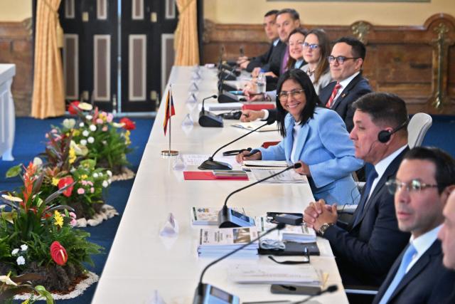 Venezuela's acting President Delcy Rodriguez meets with US Secretary of Energy Chris Wright's delegation at the Miraflores Presidential Palace in Caracas on February 11, 2026. US Energy Secretary Chris Wright arrived in Venezuela on February 11 for talks with acting president Delcy Rodriguez and oil industry executives on harnessing the country's vast crude reserves. (Photo by Juan BARRETO / AFP)