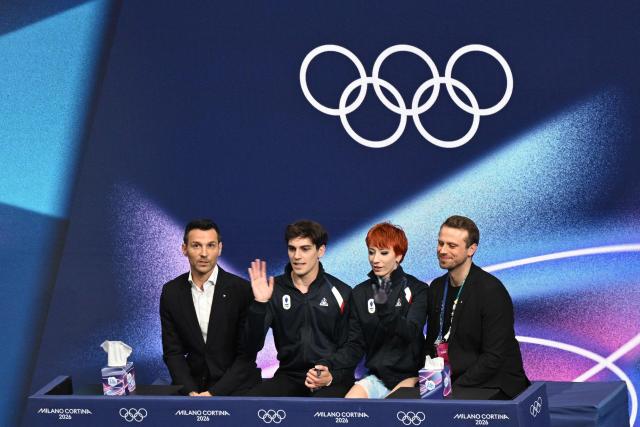 France's Evgeniia Lopareva (2nd R) and France's Geoffrey Brissaud (2nd L) react in the kiss and cry area after competing in the figure skating ice dance-free dance final during the Milano Cortina 2026 Winter Olympic Games at Milano Ice Skating Arena in Milan on February 11, 2026. (Photo by Antonin THUILLIER / AFP)