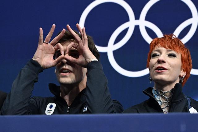 France's Evgeniia Lopareva and France's Geoffrey Brissaud react in the kiss and cry area after competing in the figure skating ice dance-free dance final during the Milano Cortina 2026 Winter Olympic Games at Milano Ice Skating Arena in Milan on February 11, 2026. (Photo by Gabriel BOUYS / AFP)