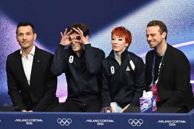 France's Evgeniia Lopareva (2nd R) and France's Geoffrey Brissaud (2nd L) react in the kiss and cry area after competing in the figure skating ice dance-free dance final during the Milano Cortina 2026 Winter Olympic Games at Milano Ice Skating Arena in Milan on February 11, 2026. (Photo by Antonin THUILLIER / AFP)
