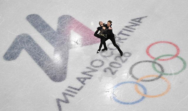 Lithuania's Allison Reed and Lithuania's Saulius Ambrulevicius compete in the figure skating ice dance-free dance final during the Milano Cortina 2026 Winter Olympic Games at Milano Ice Skating Arena in Milan on February 11, 2026. (Photo by Antonin THUILLIER / AFP)