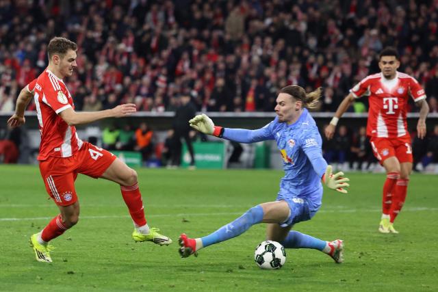 Bayern Munich's Croatian defender #44 Josip Stanisic is fouled by Leipzig's Belgian goalkeeper #26 Maarten Vandevoordt giving away a penalty during the German Cup (DFB-Pokal) quarter-final football match between FC Bayern Munich and RB Leipzig in Munich, southern Germany on February 11, 2026. (Photo by Alexandra BEIER / AFP) / DFB REGULATIONS PROHIBIT ANY USE OF PHOTOGRAPHS AS IMAGE SEQUENCES AND QUASI-VIDEO.