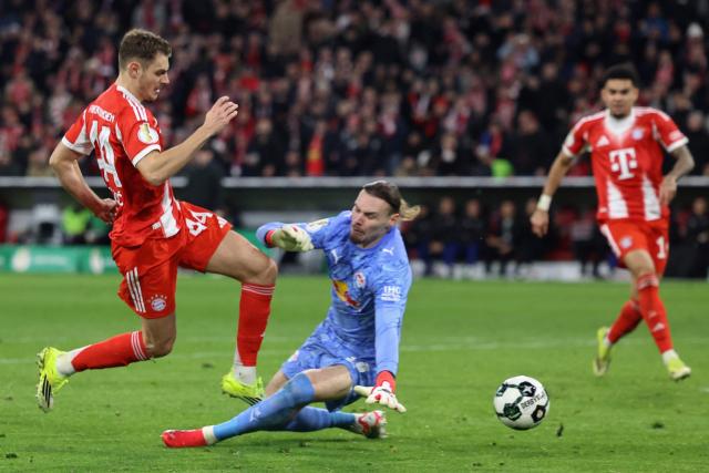 Bayern Munich's Croatian defender #44 Josip Stanisic is fouled by Leipzig's Belgian goalkeeper #26 Maarten Vandevoordt giving away a penalty during the German Cup (DFB-Pokal) quarter-final football match between FC Bayern Munich and RB Leipzig in Munich, southern Germany on February 11, 2026. (Photo by Alexandra BEIER / AFP) / DFB REGULATIONS PROHIBIT ANY USE OF PHOTOGRAPHS AS IMAGE SEQUENCES AND QUASI-VIDEO.