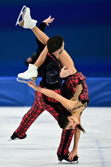Britain's Lilah Fear and Britain's Lewis Gibson compete in the figure skating ice dance-free dance final during the Milano Cortina 2026 Winter Olympic Games at Milano Ice Skating Arena in Milan on February 11, 2026. (Photo by JULIEN DE ROSA / AFP)
