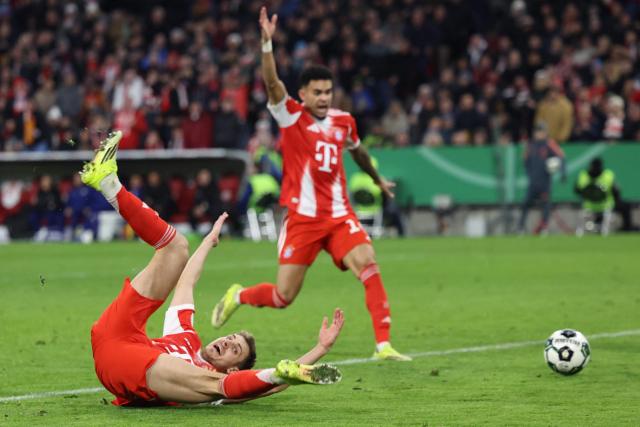 Bayern Munich's Croatian defender #44 Josip Stanisic (L) was fouled by Leipzig's Belgian goalkeeper #26 Maarten Vandevoordt (not in picture) giving away a penalty during the German Cup (DFB-Pokal) quarter-final football match between FC Bayern Munich and RB Leipzig in Munich, southern Germany on February 11, 2026. (Photo by Alexandra BEIER / AFP) / DFB REGULATIONS PROHIBIT ANY USE OF PHOTOGRAPHS AS IMAGE SEQUENCES AND QUASI-VIDEO.