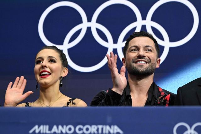 Britain's Lilah Fear and Britain's Lewis Gibson react in the kiss and cry area after competing in the figure skating ice dance-free dance final during the Milano Cortina 2026 Winter Olympic Games at Milano Ice Skating Arena in Milan on February 11, 2026. (Photo by Gabriel BOUYS / AFP)