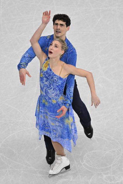 Canada's Piper Gilles and Canada's Paul Poirier react after competing in the figure skating ice dance-free dance final during the Milano Cortina 2026 Winter Olympic Games at Milano Ice Skating Arena in Milan on February 11, 2026. (Photo by Antonin THUILLIER / AFP)