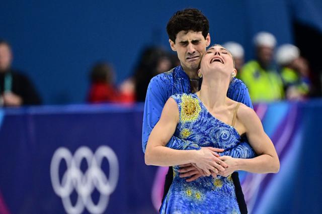 Canada's Paul Poirier and Canada's Piper Gilles react after competing in the figure skating ice dance-free dance final during the Milano Cortina 2026 Winter Olympic Games at Milano Ice Skating Arena in Milan on February 11, 2026. (Photo by JULIEN DE ROSA / AFP)