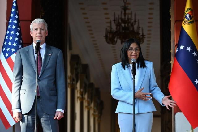 Venezuela's acting president Delcy Rodriguez (R) speaks next to US Secretary of Energy Chris Wright during a press conference after a meeting at the Miraflores Presidential Palace in Caracas on February 11, 2026. US Energy Secretary Chris Wright arrived in Venezuela on February 11 for talks with acting president Delcy Rodriguez and oil industry executives on harnessing the country's vast crude reserves. (Photo by Juan BARRETO / AFP)