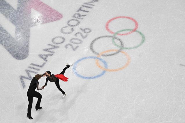 USA's Madison Chock and USA's Evan Bates compete in the figure skating ice dance-free dance final during the Milano Cortina 2026 Winter Olympic Games at Milano Ice Skating Arena in Milan on February 11, 2026. (Photo by Antonin THUILLIER / AFP)
