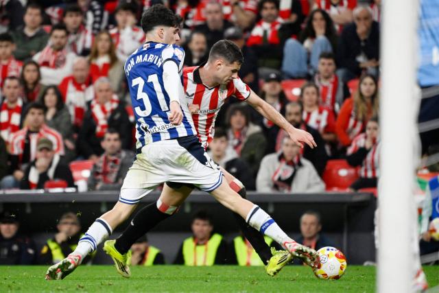 Real Sociedad's Spanish defender #31 Jon Martin and Athletic Bilbao's Spanish forward #11 Gorka Guruzeta fight for the ball during the Spanish Copa del Rey (King's Cup) semi final first leg football match between Athletic Club Bilbao and Real Sociedad at San Mames Stadium in Bilbao on February 11, 2026. (Photo by ANDER GILLENEA / AFP)