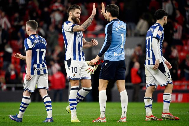 Real Sociedad's Croatian defender #16 Duje Caleta Car and Real Sociedad's Spanish goalkeeper #01 Alex Remiro celebrate at the end of the Spanish Copa del Rey (King's Cup) semi final first leg football match between Athletic Club Bilbao and Real Sociedad at San Mames Stadium in Bilbao on February 11, 2026. (Photo by ANDER GILLENEA / AFP)