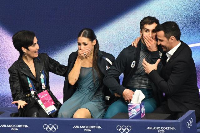 France's Laurence Fournier Beaudry (2nd L) and France's Guillaume Cizeron (2nd R) react in the kiss and cry area after competing in the figure skating ice dance-free dance final during the Milano Cortina 2026 Winter Olympic Games at Milano Ice Skating Arena in Milan on February 11, 2026. (Photo by Antonin THUILLIER / AFP)