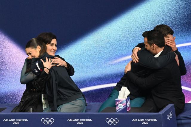 France's Laurence Fournier Beaudry (2nd L) and France's Guillaume Cizeron (2nd R) react in the kiss and cry area after competing in the figure skating ice dance-free dance final during the Milano Cortina 2026 Winter Olympic Games at Milano Ice Skating Arena in Milan on February 11, 2026. (Photo by Antonin THUILLIER / AFP)