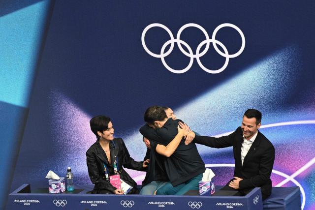 France's Laurence Fournier Beaudry (2nd L) and France's Guillaume Cizeron (2nd R) react in the kiss and cry area after competing in the figure skating ice dance-free dance final during the Milano Cortina 2026 Winter Olympic Games at Milano Ice Skating Arena in Milan on February 11, 2026. (Photo by Antonin THUILLIER / AFP)
