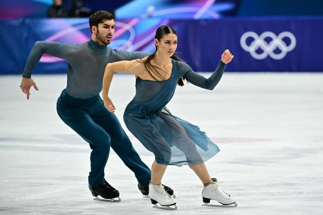 France's Laurence Fournier Beaudry and Guillaume Cizeron compete in the figure skating ice dance-free dance final during the Milano Cortina 2026 Winter Olympic Games at Milano Ice Skating Arena in Milan on February 11, 2026. (Photo by JULIEN DE ROSA / AFP)