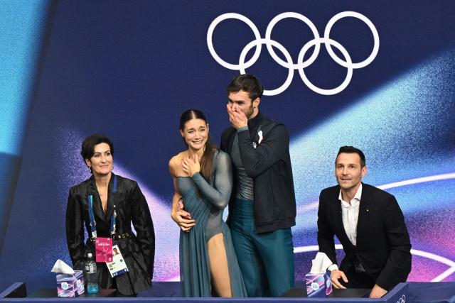 France's Laurence Fournier Beaudry (2nd L) and France's Guillaume Cizeron (2nd R) react in the kiss and cry area after competing in the figure skating ice dance-free dance final during the Milano Cortina 2026 Winter Olympic Games at Milano Ice Skating Arena in Milan on February 11, 2026. (Photo by Antonin THUILLIER / AFP)
