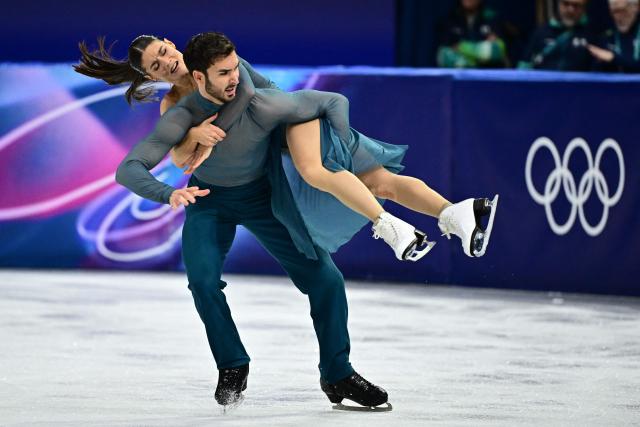 France's Laurence Fournier Beaudry and Guillaume Cizeron compete in the figure skating ice dance-free dance final during the Milano Cortina 2026 Winter Olympic Games at Milano Ice Skating Arena in Milan on February 11, 2026. (Photo by JULIEN DE ROSA / AFP)