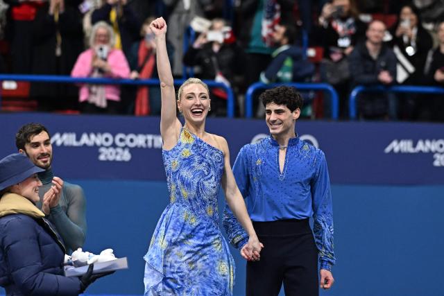Bronze medallists Canada's Paul Poirier and Canada's Piper Gilles pose on the podium after the figure skating ice dance-free dance final during the Milano Cortina 2026 Winter Olympic Games at Milano Ice Skating Arena in Milan on February 11, 2026. (Photo by Gabriel BOUYS / AFP)