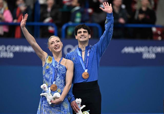 Bronze medallists Canada's Paul Poirier and Canada's Piper Gilles pose on the podium after the figure skating ice dance-free dance final during the Milano Cortina 2026 Winter Olympic Games at Milano Ice Skating Arena in Milan on February 11, 2026. (Photo by Gabriel BOUYS / AFP)