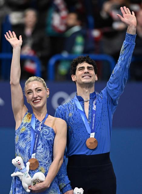 Bronze medallists Canada's Paul Poirier and Canada's Piper Gilles pose on the podium after the figure skating ice dance-free dance final during the Milano Cortina 2026 Winter Olympic Games at Milano Ice Skating Arena in Milan on February 11, 2026. (Photo by Gabriel BOUYS / AFP)