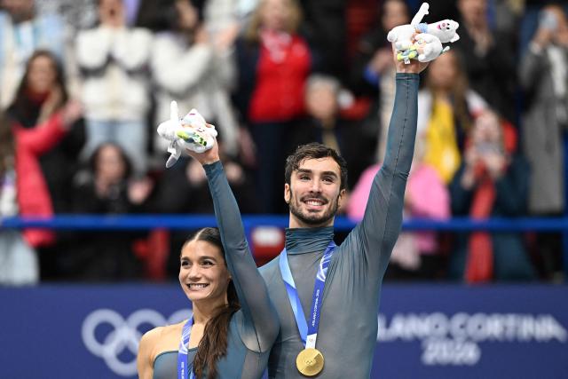 Gold medallists France's Laurence Fournier Beaudry and France's Guillaume Cizeron pose on the podium after the figure skating ice dance-free dance final during the Milano Cortina 2026 Winter Olympic Games at Milano Ice Skating Arena in Milan on February 11, 2026. (Photo by Gabriel BOUYS / AFP)