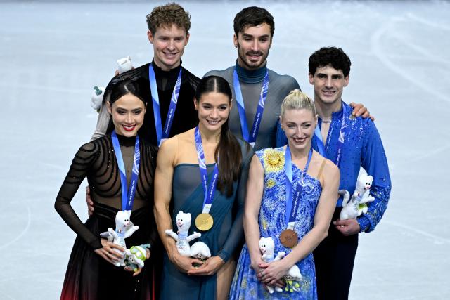 (L-R) Silver medallists USA's Madison Chock and Evan Bates, gold medallists France's Laurence Fournier Beaudry and Guillaume Cizeron and bronze medallists Canada's Piper Gilles and Paul Poirier pose on the podium of the figure skating ice dance-free dance final during the Milano Cortina 2026 Winter Olympic Games at Milano Ice Skating Arena in Milan on February 11, 2026. (Photo by WANG Zhao / AFP)
