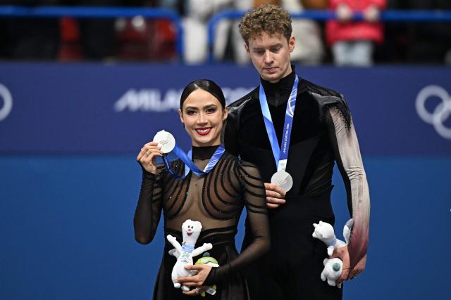 Silver medallists USA's Evan Bates and USA's Madison Chock pose on the podium after the figure skating ice dance-free dance final during the Milano Cortina 2026 Winter Olympic Games at Milano Ice Skating Arena in Milan on February 11, 2026. (Photo by Gabriel BOUYS / AFP)