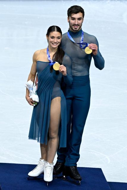 Gold medallists France's Laurence Fournier Beaudry and Guillaume Cizeron pose on the podium of the figure skating ice dance-free dance final during the Milano Cortina 2026 Winter Olympic Games at Milano Ice Skating Arena in Milan on February 11, 2026. (Photo by WANG Zhao / AFP)