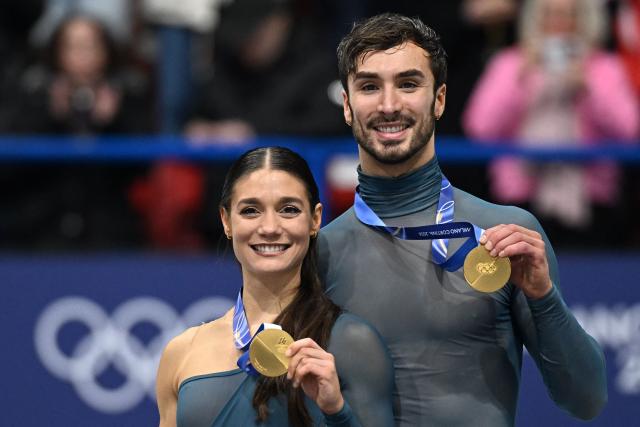 Gold medallists France's Laurence Fournier Beaudry and Guillaume Cizeron pose on the podium of the figure skating ice dance-free dance final during the Milano Cortina 2026 Winter Olympic Games at Milano Ice Skating Arena in Milan on February 11, 2026. (Photo by Gabriel BOUYS / AFP)