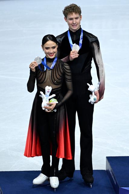 Silver medallists USA's Madison Chock and Evan Bates pose on the podium of the figure skating ice dance-free dance final during the Milano Cortina 2026 Winter Olympic Games at Milano Ice Skating Arena in Milan on February 11, 2026. (Photo by WANG Zhao / AFP)