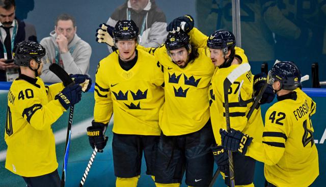 Sweden's #93 Mika Zibanejad (C) celebrates with teammates after scoring his team fourth goal during the men's preliminary round Group B Ice Hockey match between Sweden and Italy at the Milano Santagiulia Ice Hockey Arena during the Milano Cortina 2026 Winter Olympic Games in Milan, on February 11, 2026. (Photo by Alexander NEMENOV / AFP)