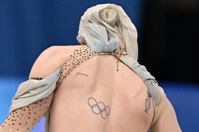An Olympic Ring tattoo is seen on Spain's Olivia Smart's back as she arrives to compete in the figure skating ice dance-free dance final during the Milano Cortina 2026 Winter Olympic Games at Milano Ice Skating Arena in Milan on February 11, 2026. (Photo by Gabriel BOUYS / AFP)