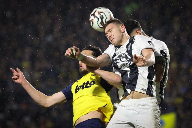 Royale Union Saint-Gilloise's English defender #16 Christian Burgess and Royal Charleroi SC's French forward #21 Aurelien Scheidler jump for the ball during the second leg of the Belgium 'Croky Cup' semifinal football match between Sporting Charleroi and Royale Union Saint-Gilloise at Stade Joseph Marien in Brussels on February 11, 2026. (Photo by VIRGINIE LEFOUR / Belga / AFP) / Belgium OUT