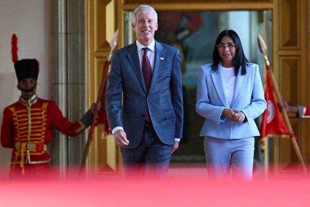 Venezuela's acting president Delcy Rodriguez (R), talks with US Secretary of Energy Chris Wright as they walk to a press conference after a meeting at the Miraflores Presidential Palace in Caracas on February 11, 2026. US Energy Secretary Chris Wright arrived in Venezuela on February 11 for talks with acting president Delcy Rodriguez and oil industry executives on harnessing the country's vast crude reserves. (Photo by Juan BARRETO / AFP)