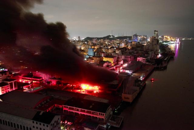 This aerial view shows the smoke over a fire in an apartment tower in the central area of the bay of Guayaquil, Ecuador, on February 11, 2026. (Photo by Marcos PIN / AFP)