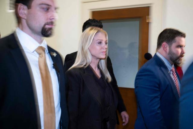 US Attorney General Pam Bondi is surrounded by Secret Service agents as she leaves Capitol Hill after testifiying  before a House Judiciary Committee hearing on "Oversight of the Department of Justice" on Capitol Hill in Washington, DC, on February 11, 2026. Congressional Democrats accused US Attorney General Pam Bondi of engaging in a "cover-up" of the Jeffrey Epstein files and turning the Justice Department into a weapon of retribution for President Donald Trump. Bondi, testifying before the House Judiciary Committee, defended the department's handling of the records about the convicted sex offender at a fiery hearing attended by a number of Epstein's victims. (Photo by ROBERTO SCHMIDT / AFP)