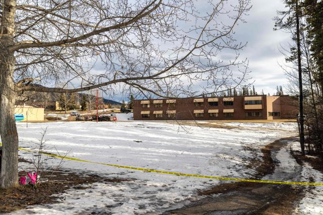 Police tape marks off Tumbler Ridge Secondary School where a mass shooting took place in the small town of Tumbler Ridge, British Columbia, on February 11, 2026. Canadian police said February 11 an 18-year-old carried out a mass shooting in a remote mining town, killing six people at a local school, after slaying her mother and stepbrother. Police commander Dwayne McDonald said authorities still don't know the motive in Tuesday's mass shooting in Tumbler Ridge, but the shooter, who took her own life, was known to have mental health issues. (Photo by Eagle Vision Agency / AFP)
