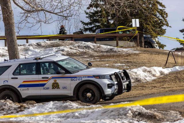 A security guard works outside Tumbler Ridge Secondary School where a mass shooting took place in the small town of Tumbler Ridge, British Columbia, on February 11, 2026. Canadian police said February 11 an 18-year-old carried out a mass shooting in a remote mining town, killing six people at a local school, after slaying her mother and stepbrother. Police commander Dwayne McDonald said authorities still don't know the motive in Tuesday's mass shooting in Tumbler Ridge, but the shooter, who took her own life, was known to have mental health issues. (Photo by Eagle Vision Agency / AFP)