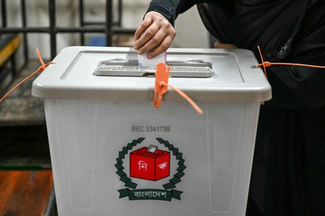 A voter casts their vote at a polling station during Bangladesh's general election in Dhaka on February 12, 2026. (Photo by MOHD RASFAN / AFP)