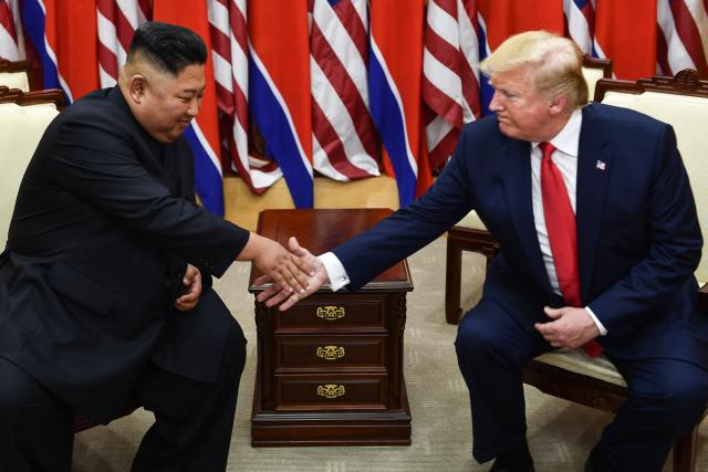 (FILES) North Korea's leader Kim Jong Un (L) and US President Donald Trump shake hands during a meeting on the south side of the Military Demarcation Line that divides North and South Korea, in the Joint Security Area (JSA) of Panmunjom in the Demilitarized zone (DMZ) on June 30, 2019. A new push to lift aid sanctions on North Korea could kickstart efforts to lure Kim Jong Un into nuclear negotiations with US President Donald Trump, analysts told AFP. (Photo by Brendan Smialowski / AFP)