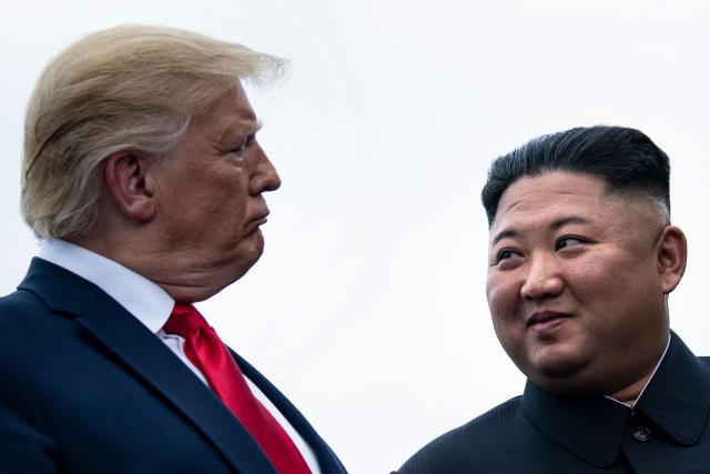 (FILES) US President Donald Trump and North Korea's leader Kim Jong-un talk before a meeting in the Demilitarized Zone(DMZ) in Panmunjom on June 30, 2019. A new push to lift aid sanctions on North Korea could kickstart efforts to lure Kim Jong Un into nuclear negotiations with US President Donald Trump, analysts told AFP. (Photo by Brendan Smialowski / AFP)