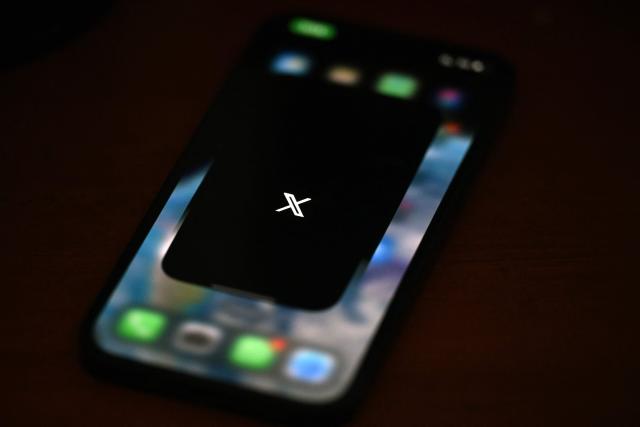 (FILES) This photo illustration shows the social media platform X (former Twitter) app on a smartphone in Rio de Janeiro, Brazil on September 18, 2024. Brazilian authorities reported on February 11, 2026, that they had ordered social media platform X to take immediate measures to prevent the creation of sexual images generated by Grok, its artificial intelligence (AI) assistant. (Photo by Mauro PIMENTEL / AFP)