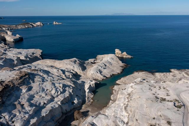 This aerial picture taken on February 3, 2026, shows Sarakiniko Beach in the Greek Aegean island of Milos. On the sloping coastline facing the Aegean Sea, the vast construction site looks like a gaping wound inflicted on the volcanic rock. ‘An ecological crime’ according to Manolis Mikelis, mayor of Milos, the Greek island in the Cyclades where this luxury hotel has begun extensive expansion work. "The geological uniqueness of Milos is known throughout the world. We don't want its identity to change," grumbles the mayor. Private villas and high-end complexes: the entire archipelago, known for its whitewashed houses and blue church domes, is caught up in a real estate fever fuelled by the tourism boom. (Photo by Aris MESSINIS / AFP)